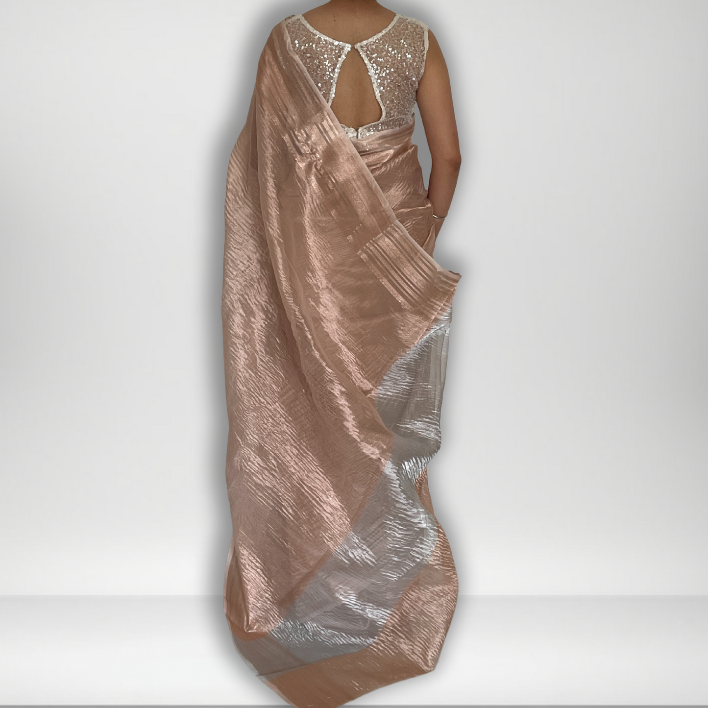 Rose gold metallic crush tissue saree with copper zari border, Work by Shobhangini. Trendy rose gold saree, ideal for festive celebrations.