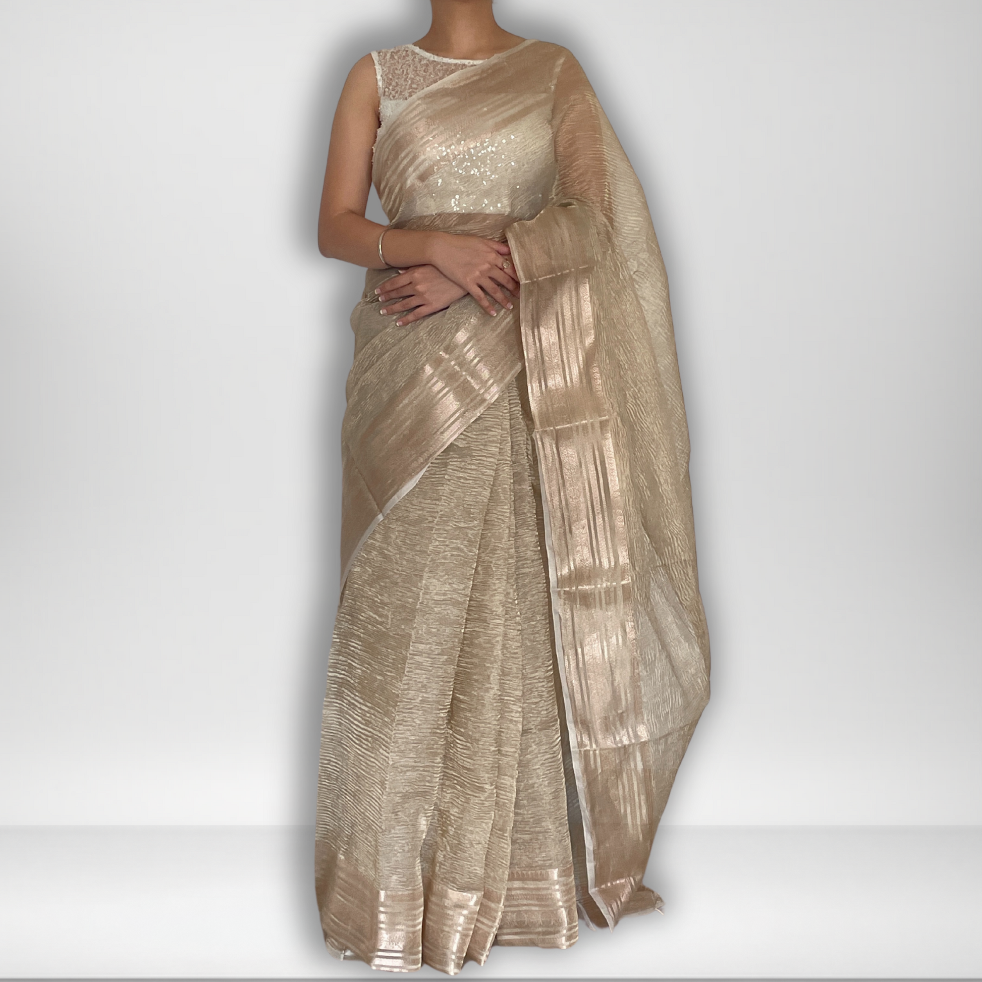 Light gold metallic crush tissue saree with copper zari border, Work by Shobhangini. Delicate light gold saree, perfect for day events.