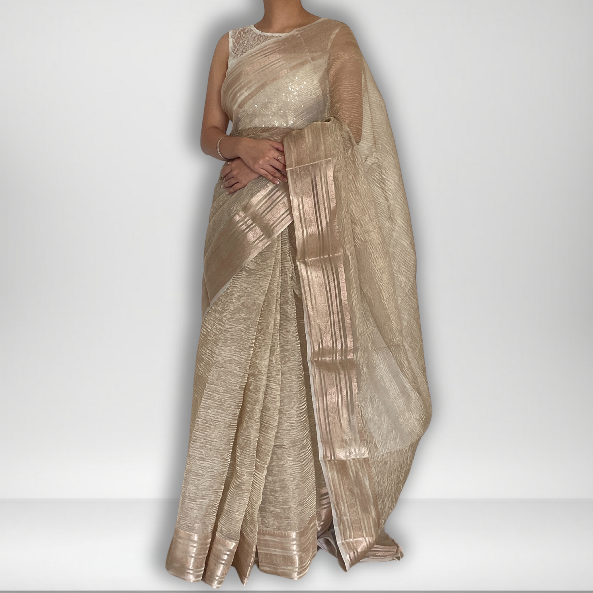 Light gold metallic crush tissue saree with copper zari border, Work by Shobhangini. Delicate light gold saree, perfect for day events.