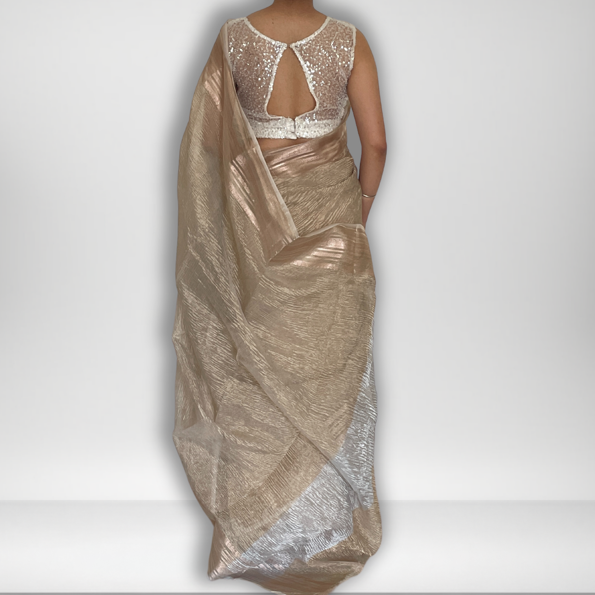 Light gold metallic crush tissue saree with copper zari border, Work by Shobhangini. Delicate light gold saree, perfect for day events.