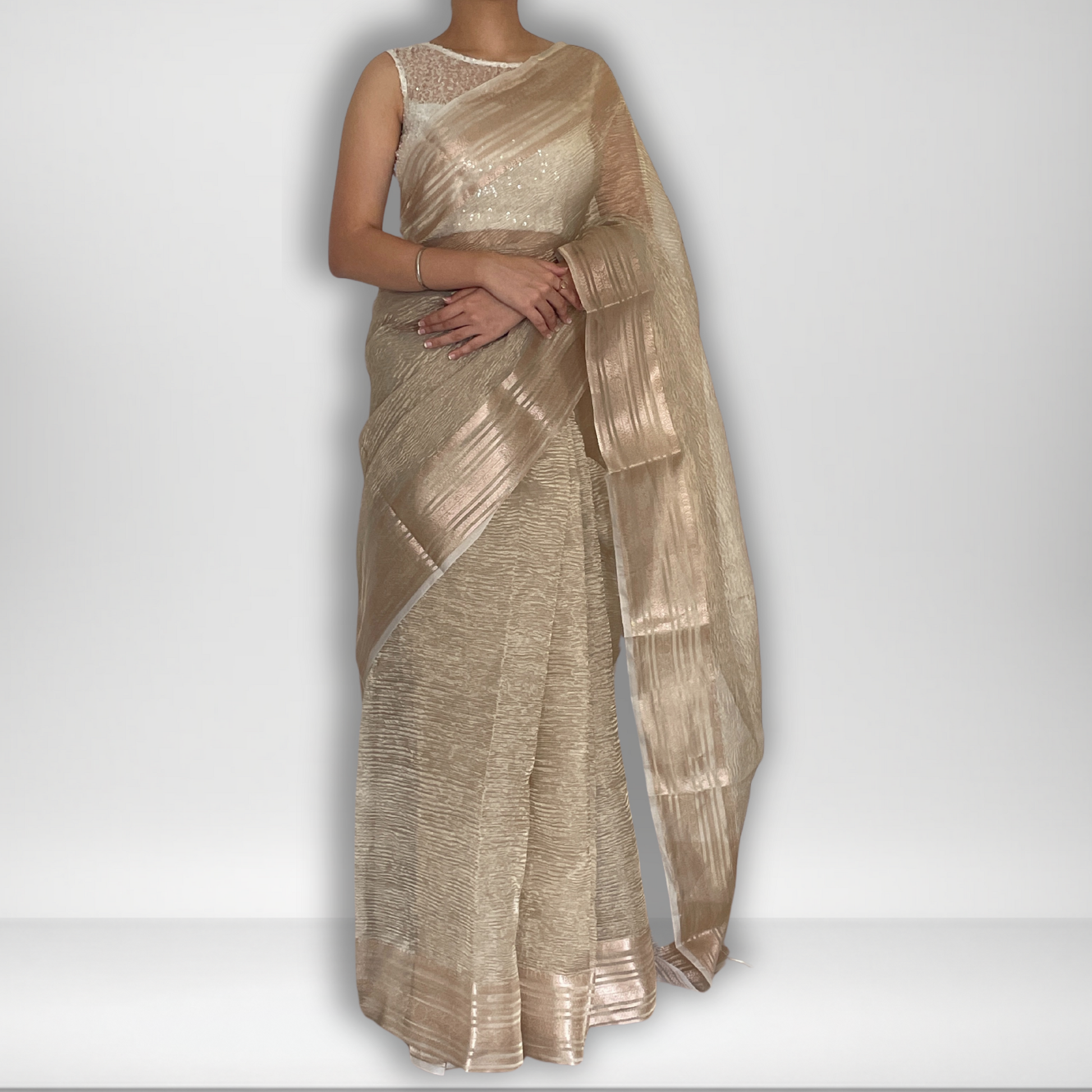 Light gold metallic crush tissue saree with copper zari border, Work by Shobhangini. Delicate light gold saree, perfect for day events.