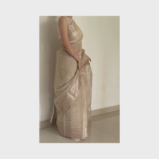 Light gold metallic crush tissue saree with copper zari border, Work by Shobhangini. Delicate light gold saree, perfect for day events.